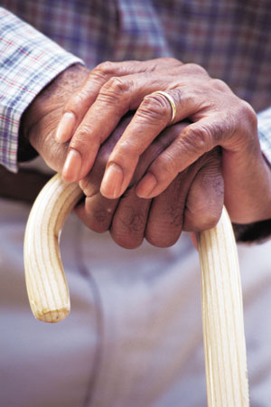elderly hands on a cane